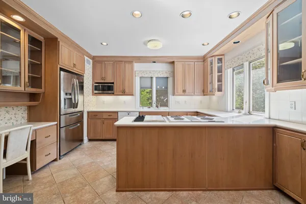 a kitchen with stainless steel appliances granite countertop a sink and cabinets
