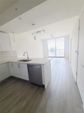 a kitchen with wooden floors and sink