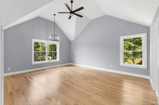 a view of a hallway with windows and stairs