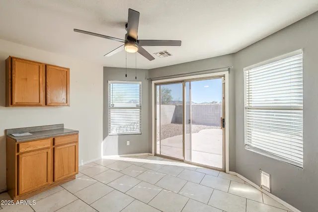 a kitchen with granite countertop a sink dishwasher and cabinets with wooden floor