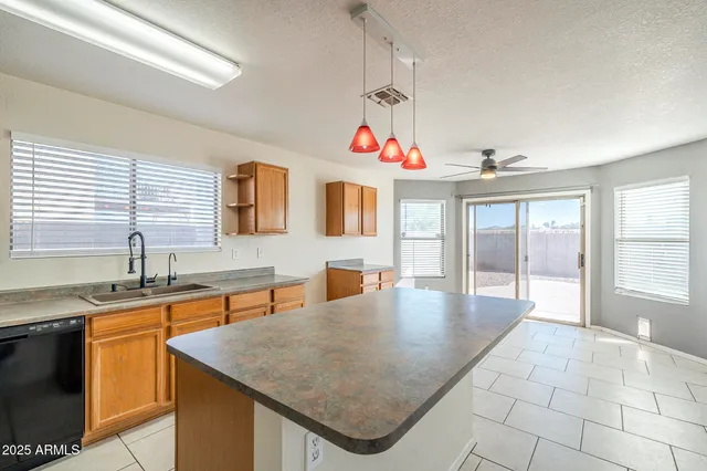 an empty room with a window and ceiling fan