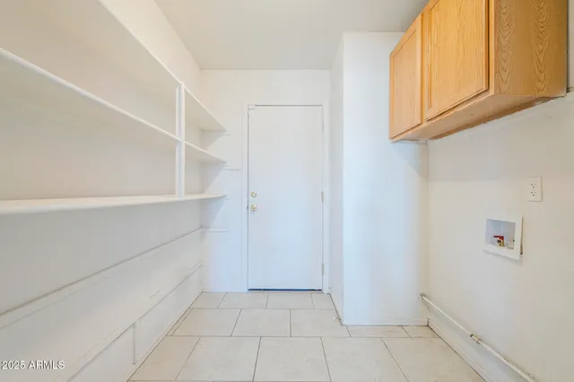 an empty room with a chandelier fan