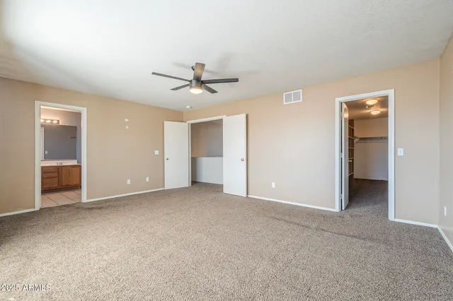 a bathroom with a granite countertop toilet a sink and a mirror