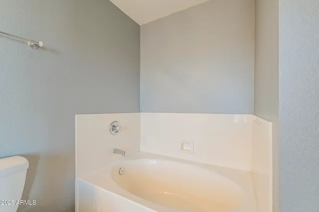 a view of a backyard with plants and patio