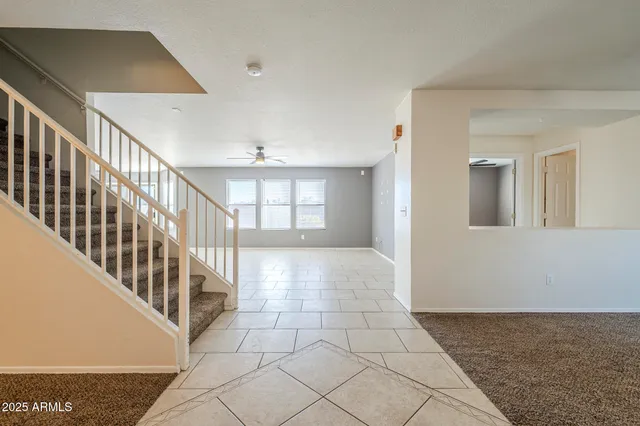 a view of a livingroom with a ceiling fan and window