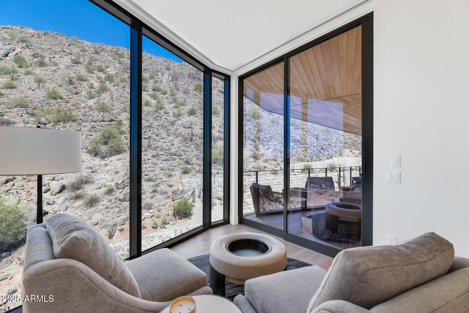 5000 East Camelback Road, Unit 407 Scottsdale, AZ 85253 - Photo 13 of 39 a living room with furniture and a floor to ceiling window