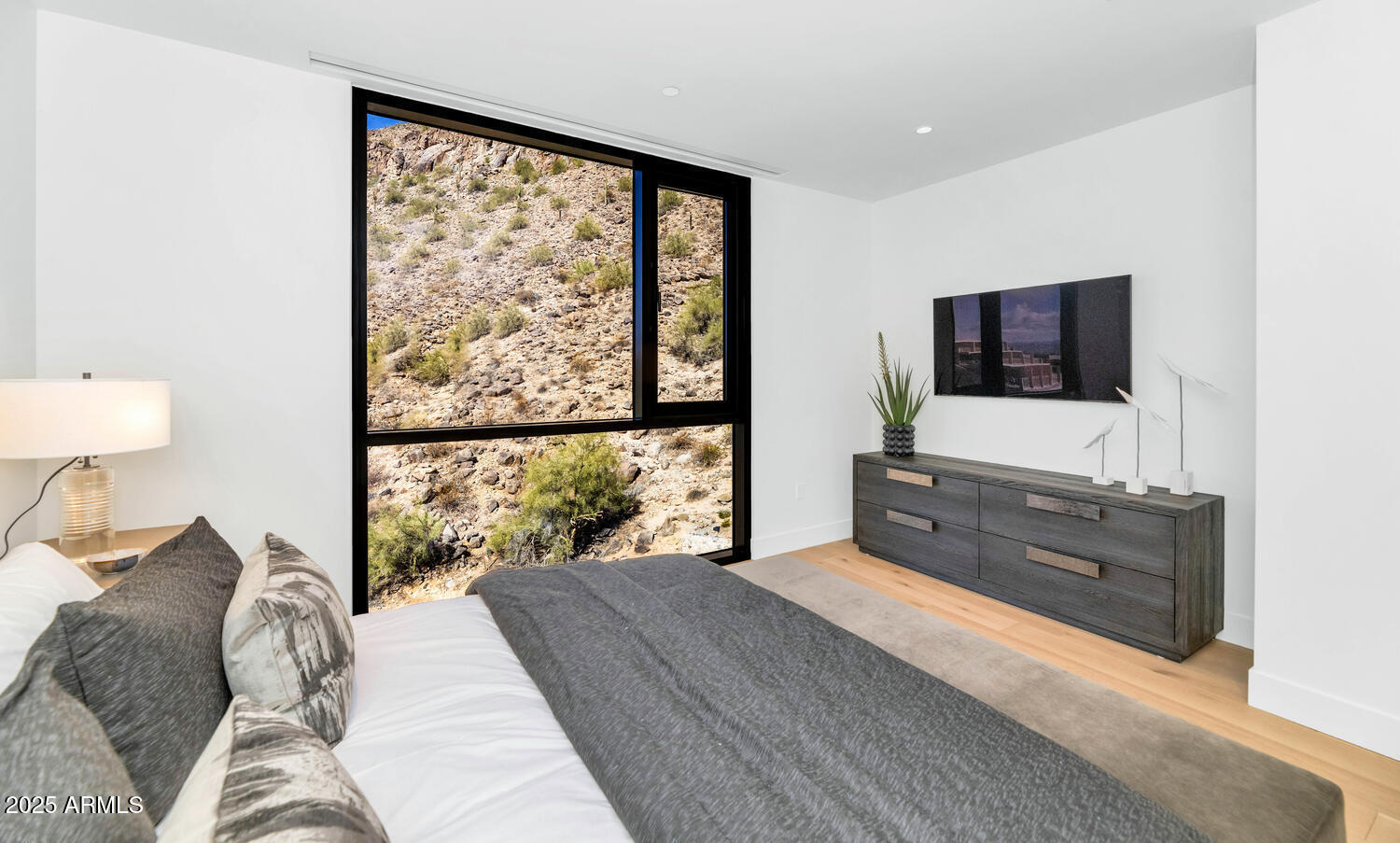 5000 East Camelback Road, Unit 407 Scottsdale, AZ 85253 - Photo 20 of 39 a bedroom with a bed and a flat screen tv