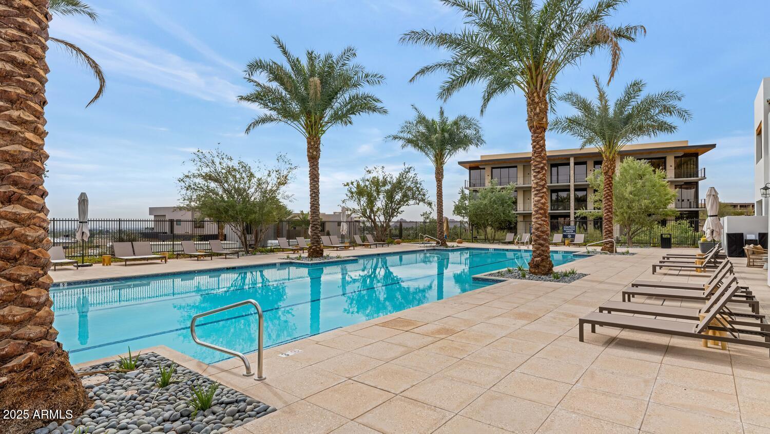 5000 East Camelback Road, Unit 407 Scottsdale, AZ 85253 - Photo 28 of 39 a view of a backyard with a patio and swimming pool