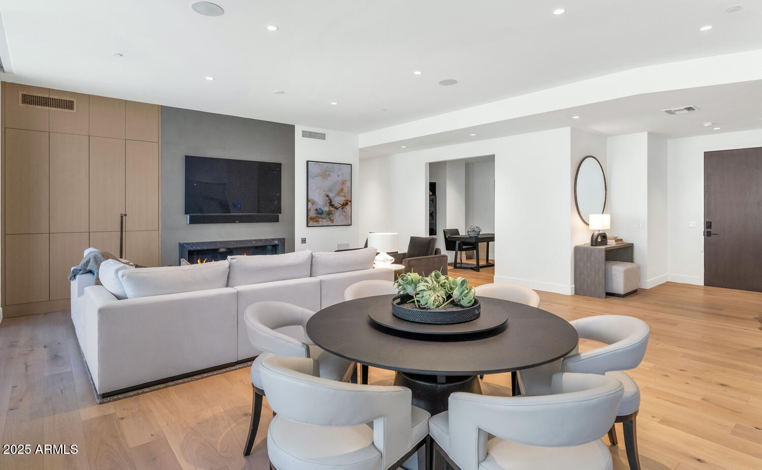 5000 East Camelback Road, Unit 407 Scottsdale, AZ 85253 - Photo 3 of 39 a living room with furniture a flat screen tv and kitchen view