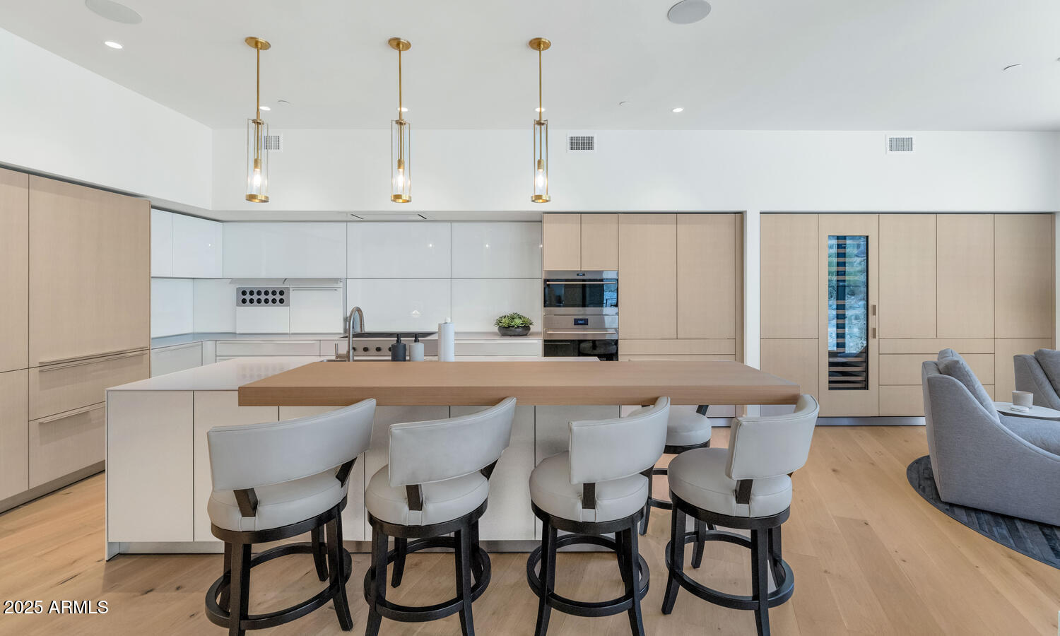 5000 East Camelback Road, Unit 407 Scottsdale, AZ 85253 - Photo 9 of 39 a kitchen with stainless steel appliances a white table chairs and a refrigerator