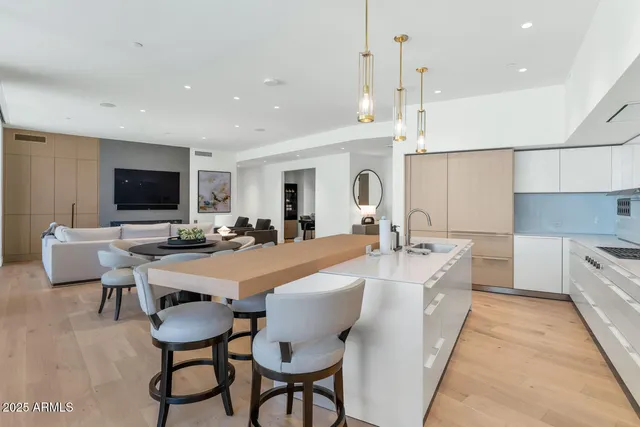 a large white kitchen with a table and chairs