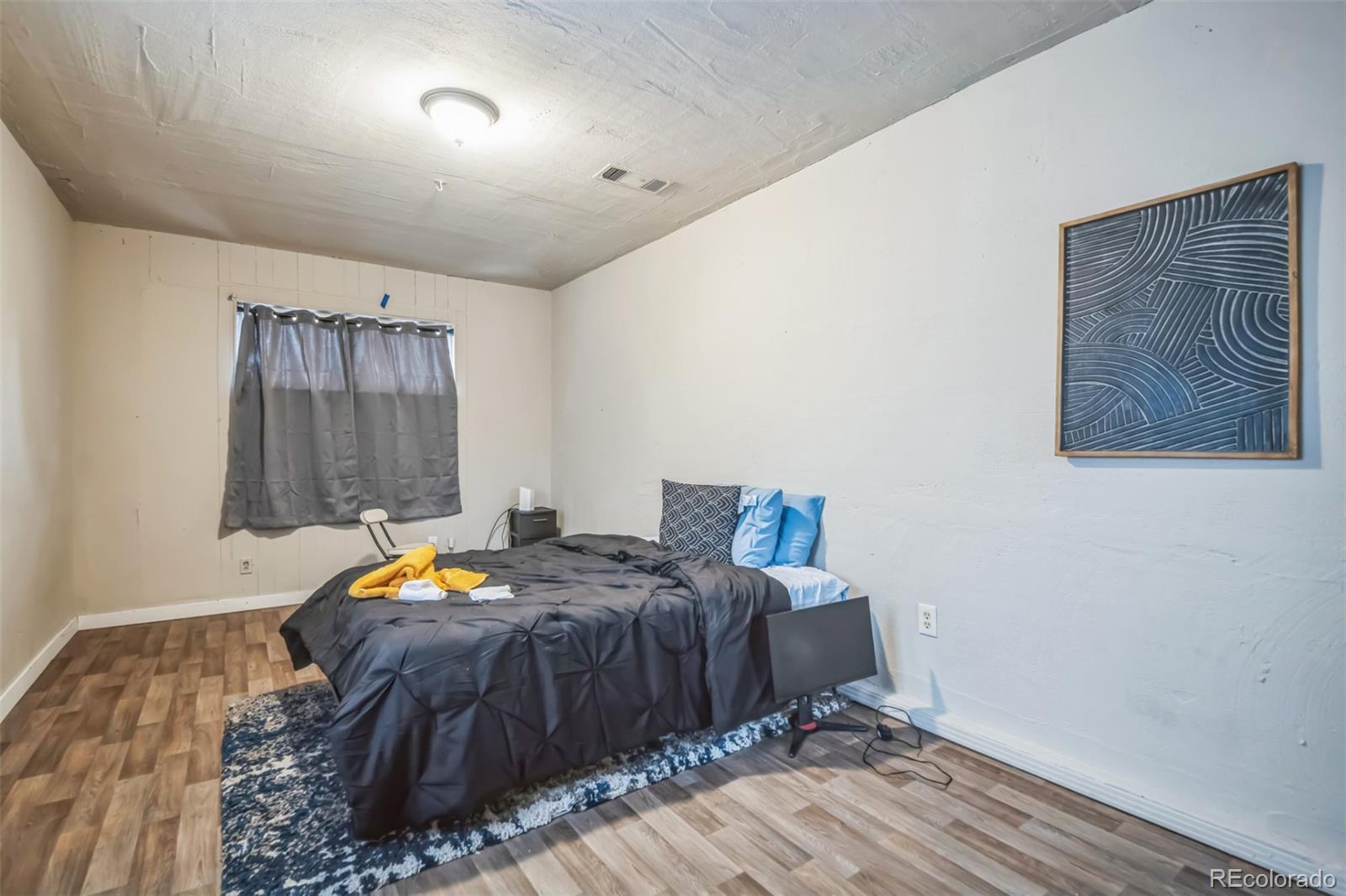 840 Tucson Street Aurora, CO 80011 - Photo 13 of 29 a bed room with a bed and a window