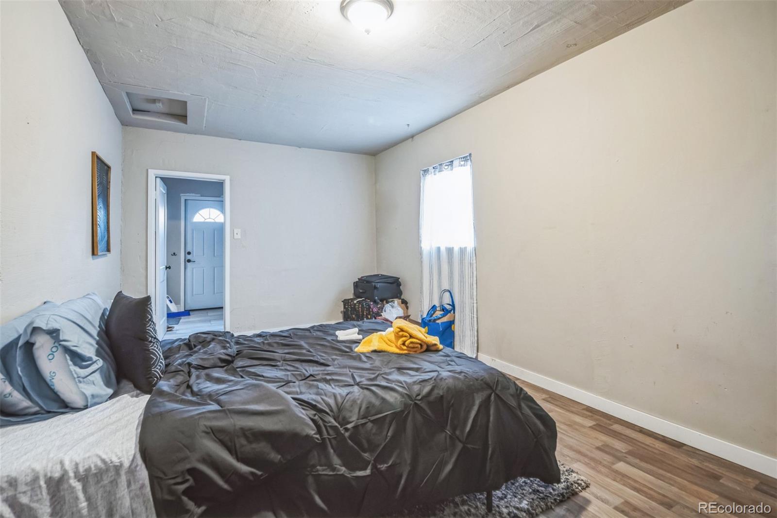 840 Tucson Street Aurora, CO 80011 - Photo 15 of 29 a bedroom with a bed and a window