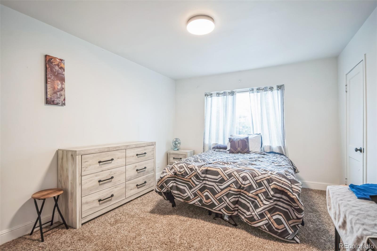 840 Tucson Street Aurora, CO 80011 - Photo 16 of 29 a bedroom with a bed and a window