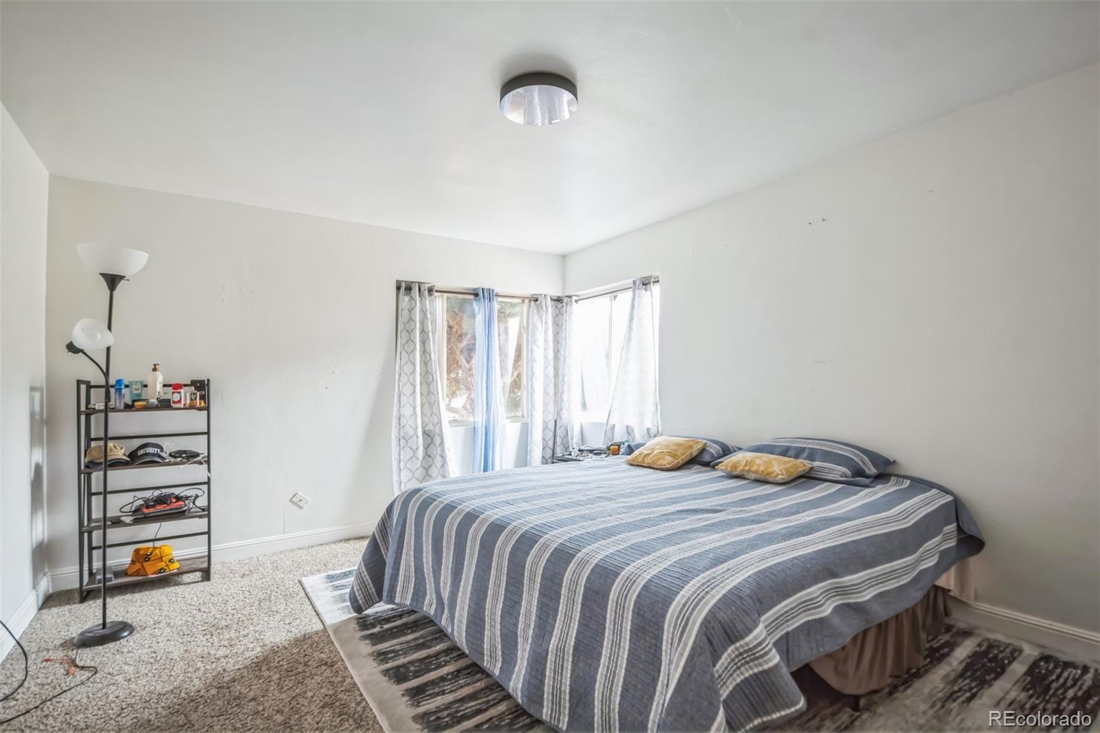 840 Tucson Street Aurora, CO 80011 - Photo 18 of 29 a bedroom with a bed and a closet
