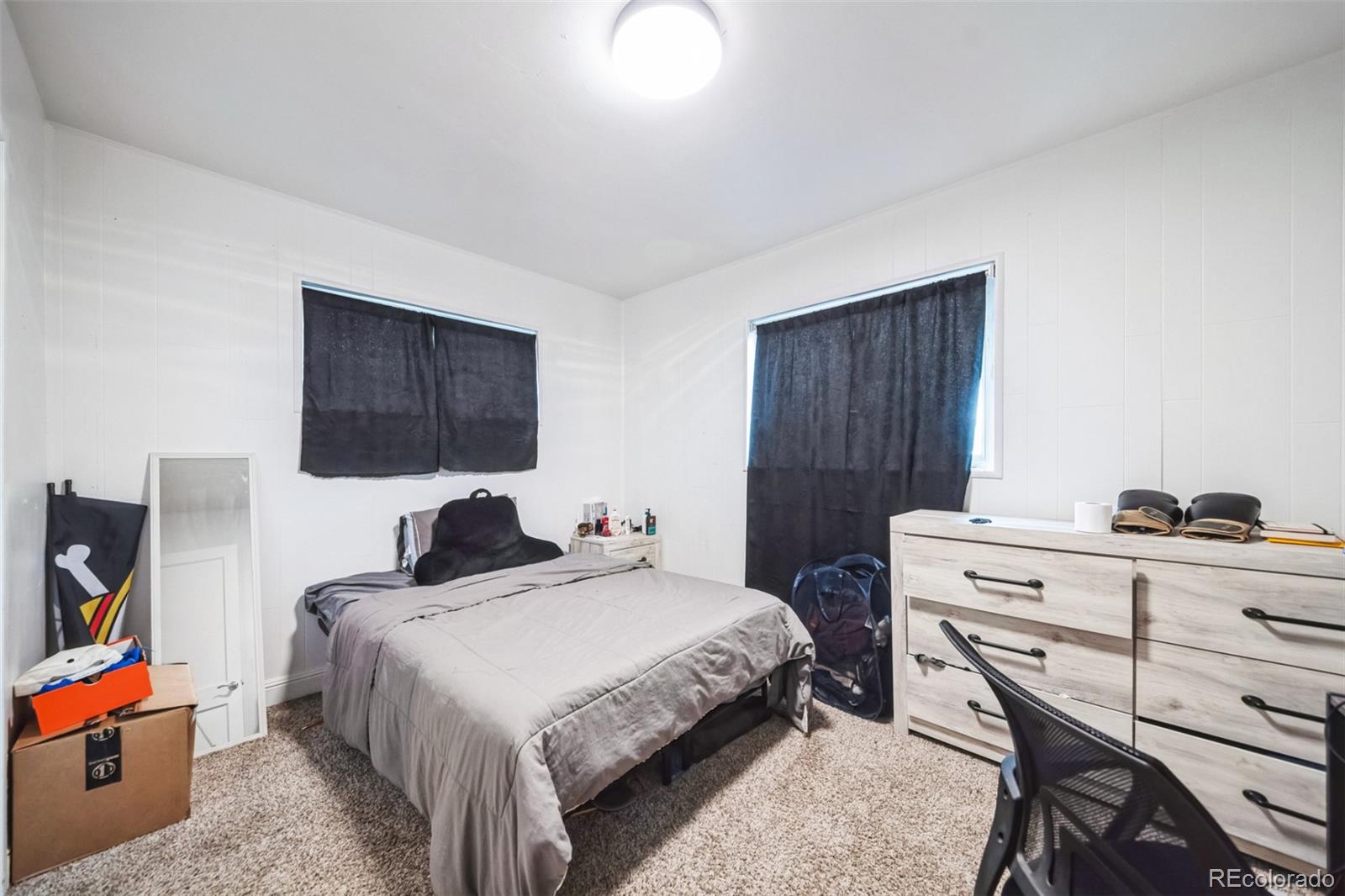 840 Tucson Street Aurora, CO 80011 - Photo 21 of 29 a bedroom with a bed and a flat screen tv