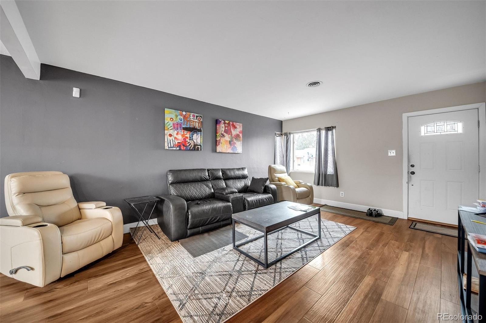 840 Tucson Street Aurora, CO 80011 - Photo 25 of 29 a living room with furniture and a wooden floor