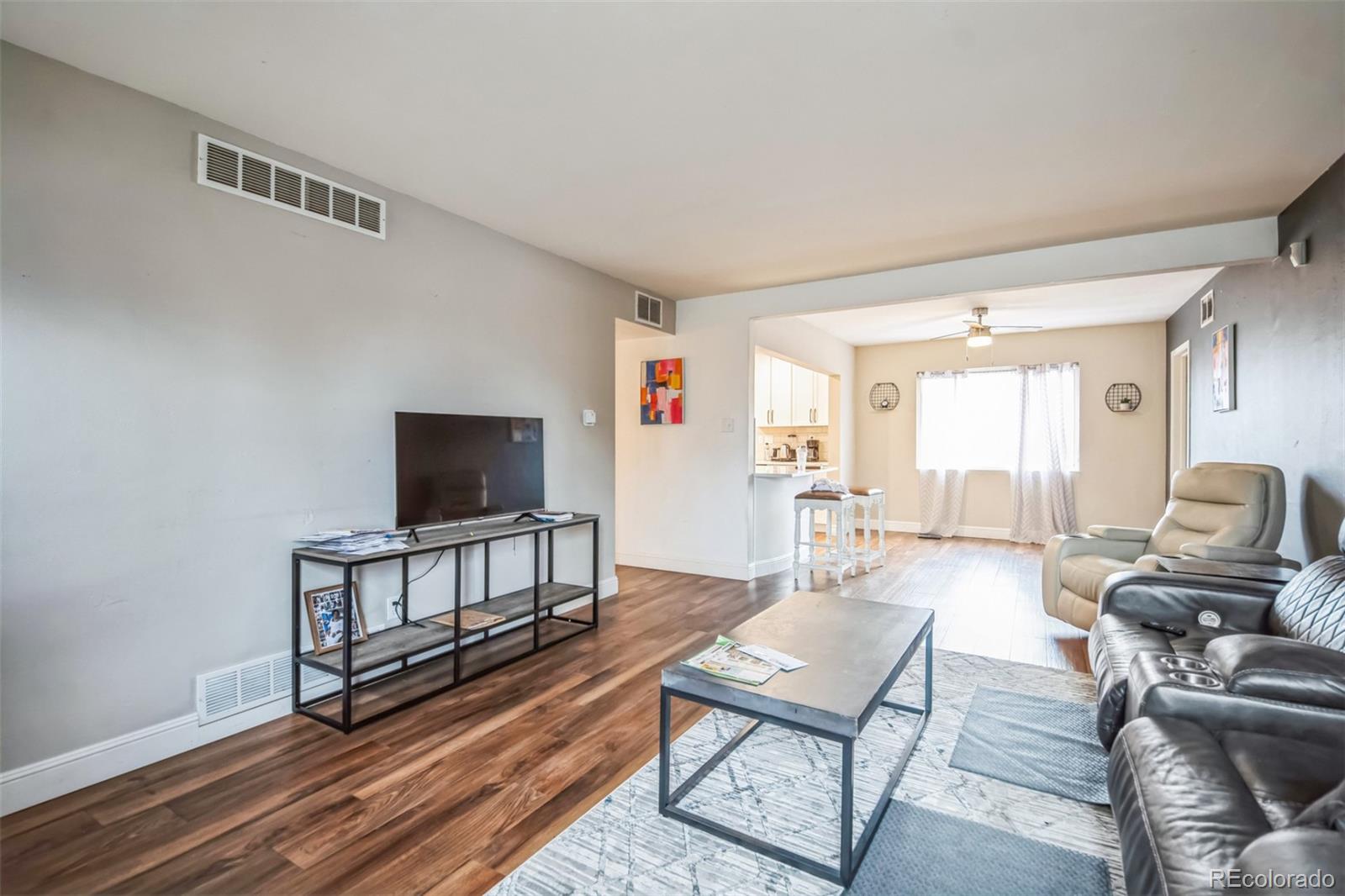 840 Tucson Street Aurora, CO 80011 - Photo 27 of 29 a living room with furniture and a flat screen tv