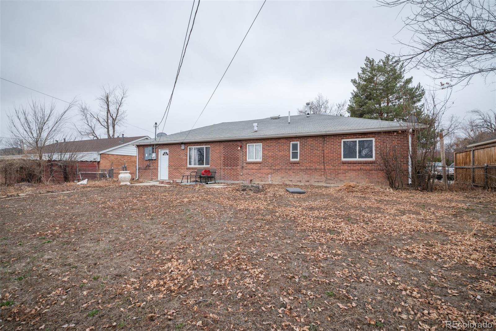 840 Tucson Street Aurora, CO 80011 - Photo 29 of 29 a front view of house with yard and trees around