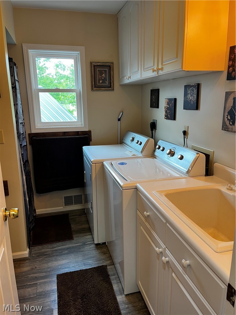 6876 Clark Road Atwater, OH 44201 - Photo 19 of 41 Clothes washing area featuring cabinets, electric dryer hookup, wood-type flooring, sink, and washing machine and dryer