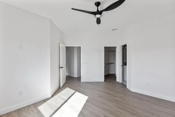 a view of empty room with wooden floor