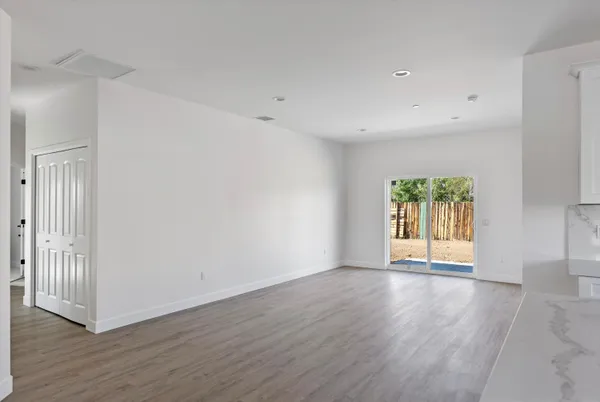 an empty room with wooden floor and a window