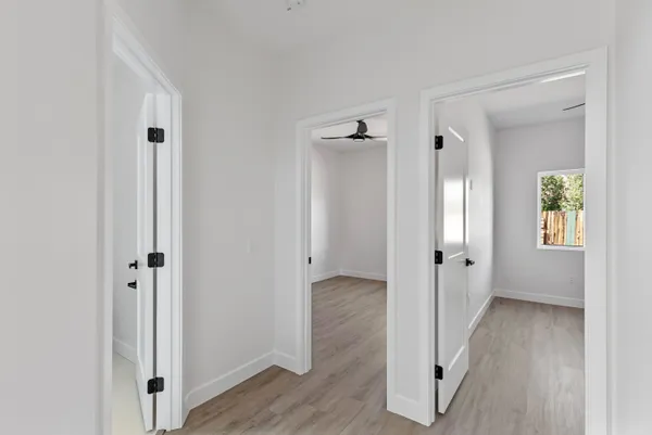 a view of a hallway with wooden floor