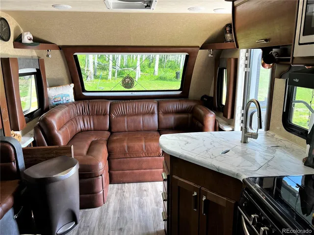 a backyard of a house with table and chairs under an umbrella