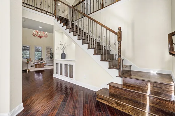 a view of entryway and hall with wooden floor