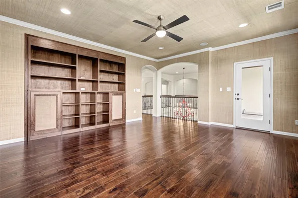 a view of empty room with wooden floor and window