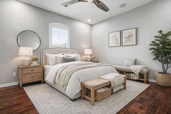 a bedroom with bed and a potted plant