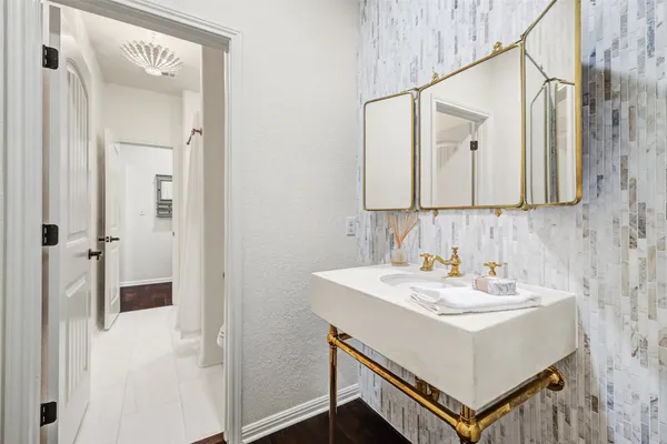 a bathroom with a sink a mirror and a shower