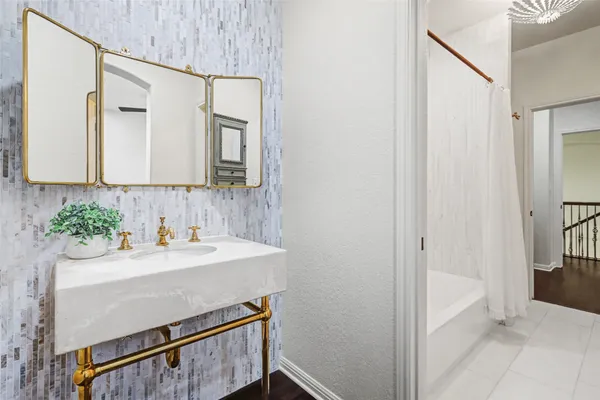 a bathroom with a sink a mirror and a bathtub