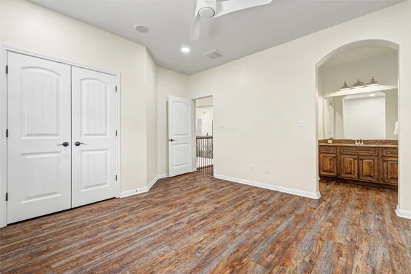 a bathroom with a granite countertop sink a mirror and a bathtub