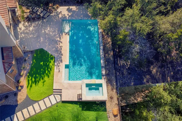 front view of a house with a yard and potted plants
