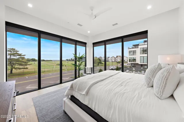 a bedroom with a large bed and a large window