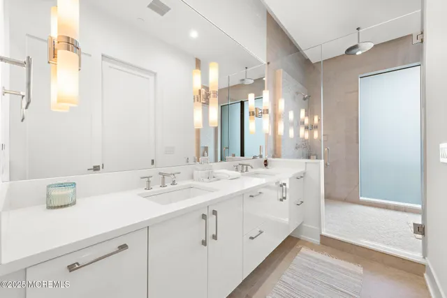 a bathroom with a double vanity sink mirror and