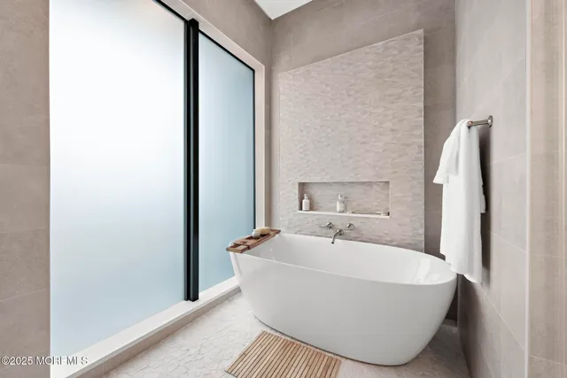 a white bath tub sitting in a bathroom