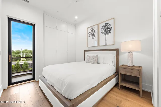 a bedroom with a bed and a night stand