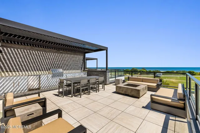 a roof deck with a table and chairs