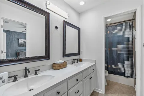 a bathroom with a sink double vanity and a mirror