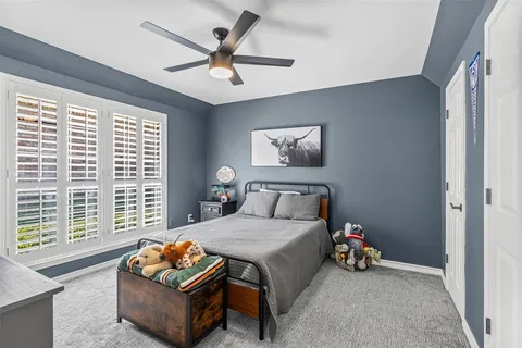a bedroom with furniture and a large window