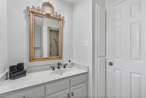 a bathroom with a sink a mirror and vanity