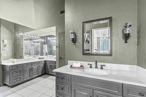 a bathroom with a granite countertop sink mirror and