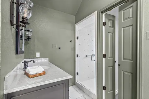 a bathroom with a sink vanity and a mirror