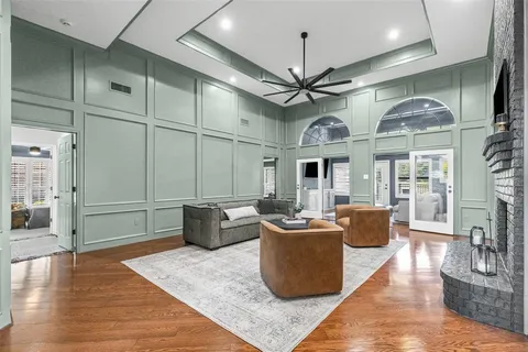 a living room with furniture a chandelier and a fireplace