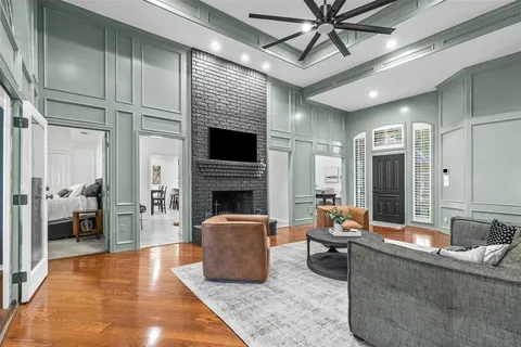 a living room with furniture a fireplace and a table