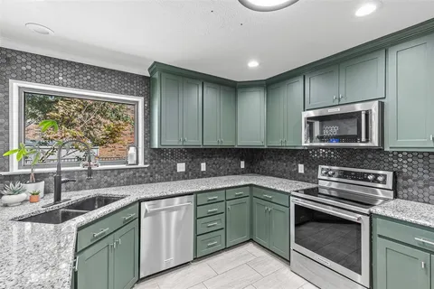 a kitchen with a sink stove and microwave