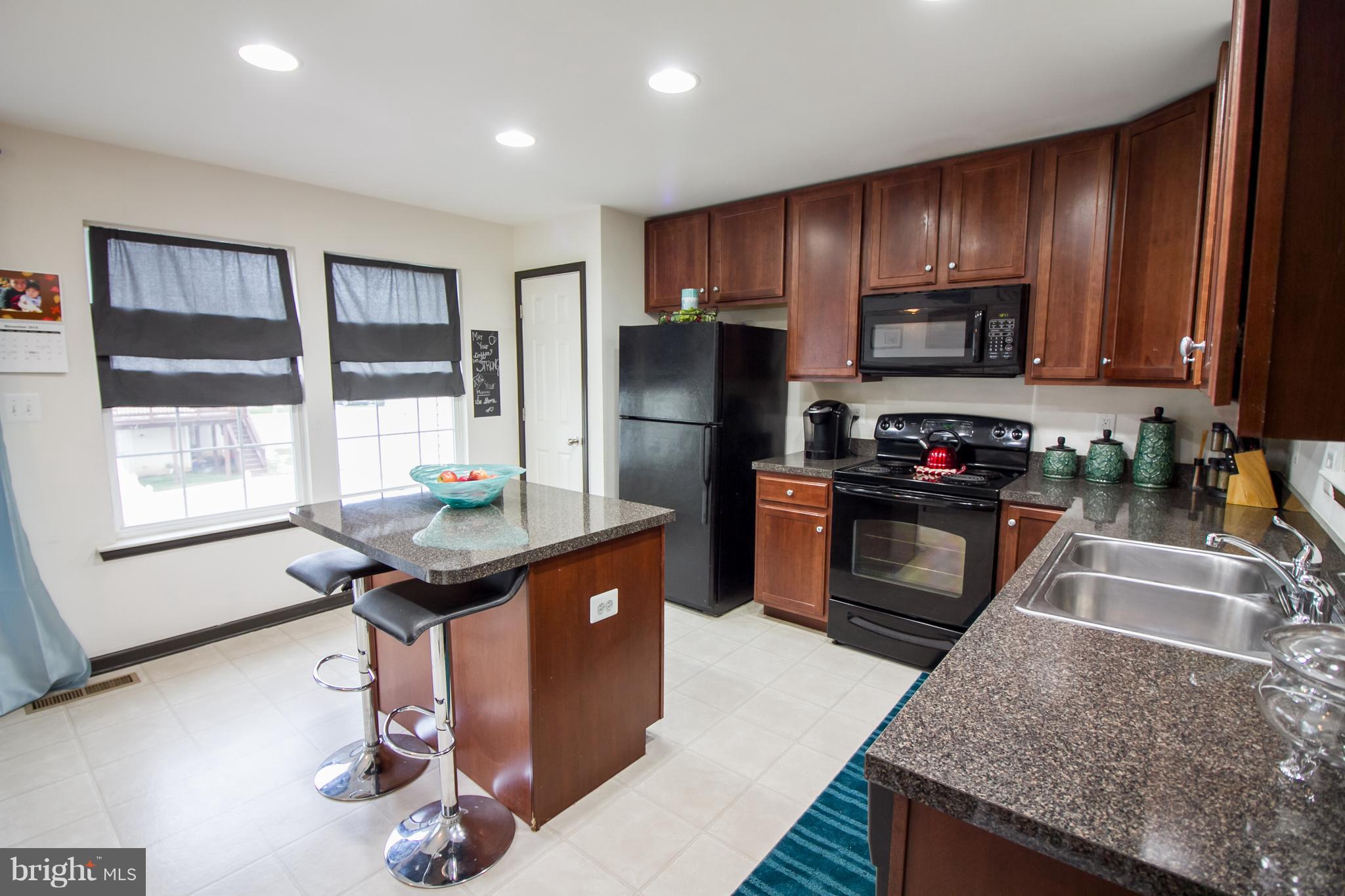 1217 Mare Street Ranson, WV 25438 - Photo 3 of 23 a kitchen with stainless steel appliances granite countertop a sink refrigerator and microwave