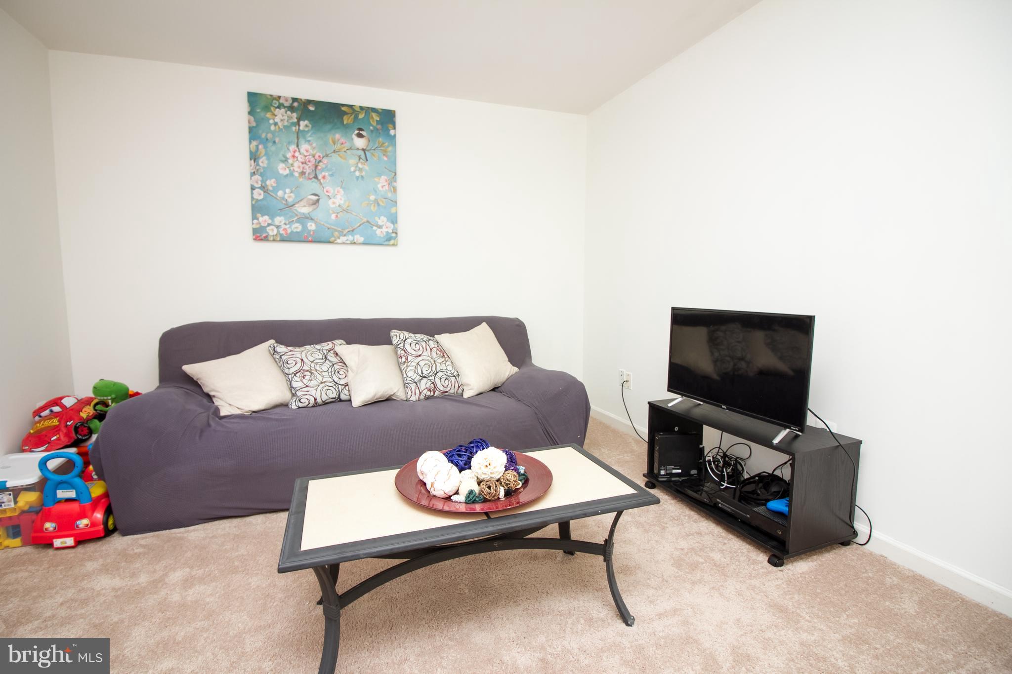 1217 Mare Street Ranson, WV 25438 - Photo 22 of 23 a living room with furniture and a flat screen tv
